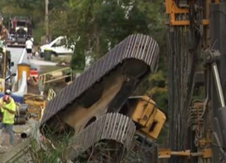 Douglas Pike closed as crews work to upright overturned excavator