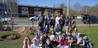 Volunteers plant a tree – and the seeds of an eco-conscious mindset – with students at Callahan School