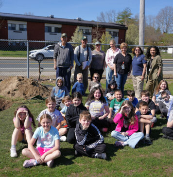 Volunteers plant a tree – and the seeds of an eco-conscious mindset – with students at Callahan School
